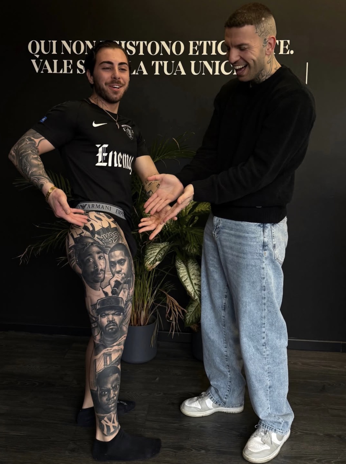 Federico Galliani in the studio beside a client's healed portrait leg sleeve