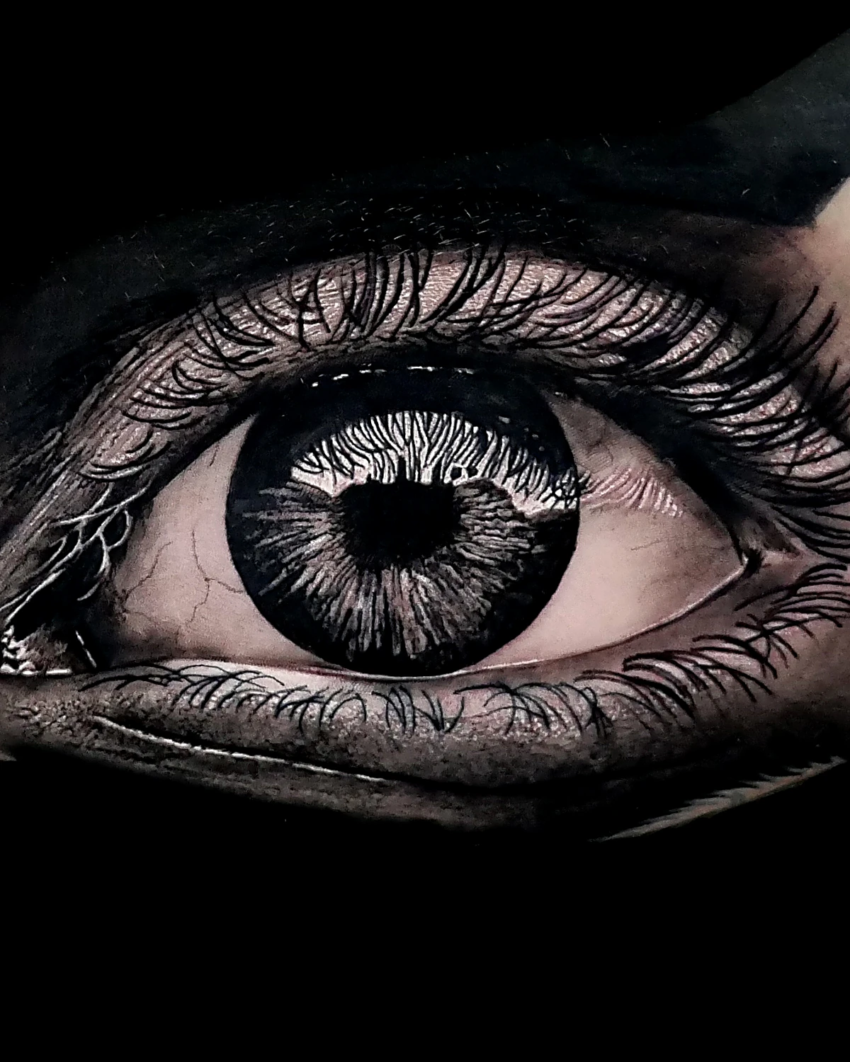 Hyper-realistic black & grey eye tattoo by Federico Galliani